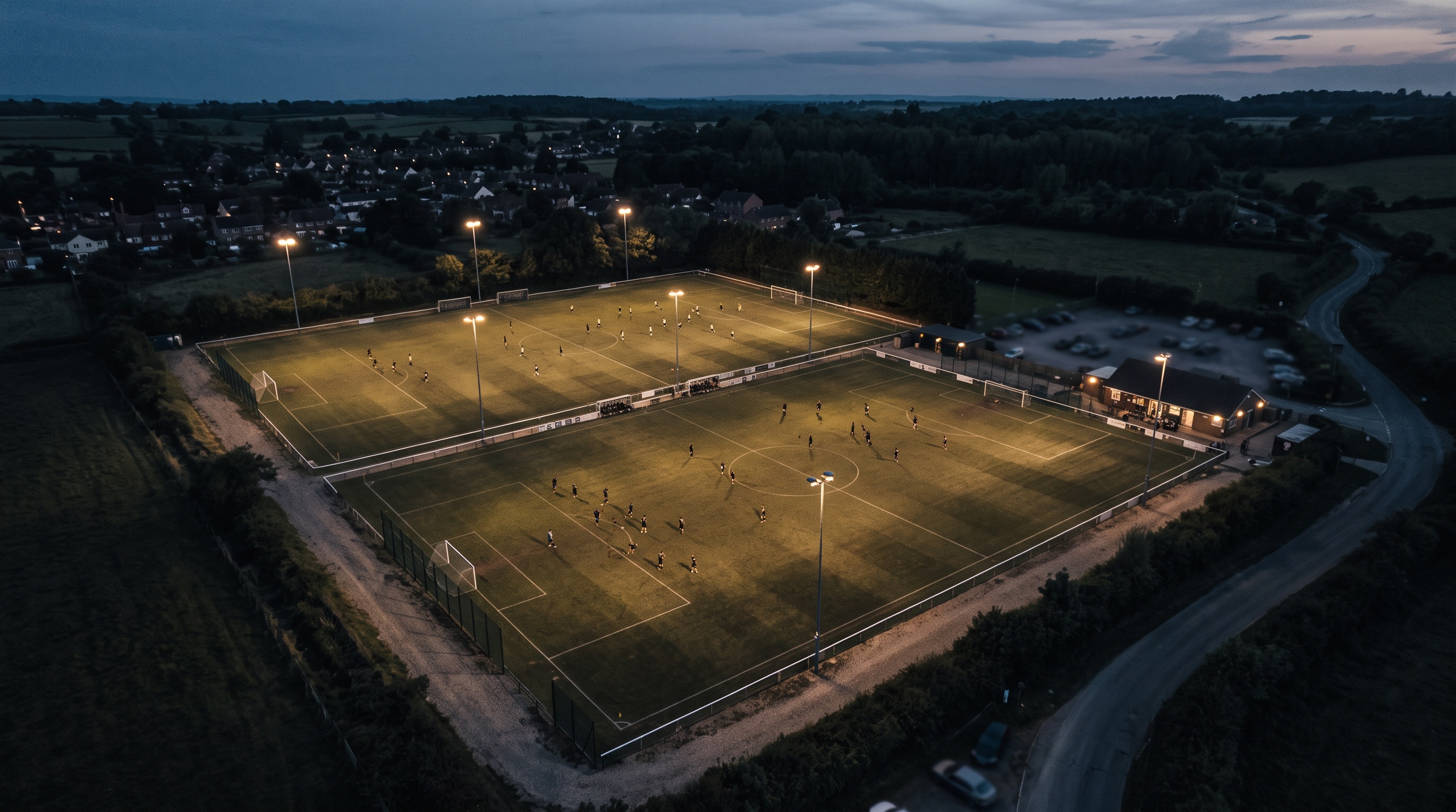 Club grounds at dusk, floodlights on